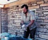 Getting ready to set the final stone in a wall, about 1986