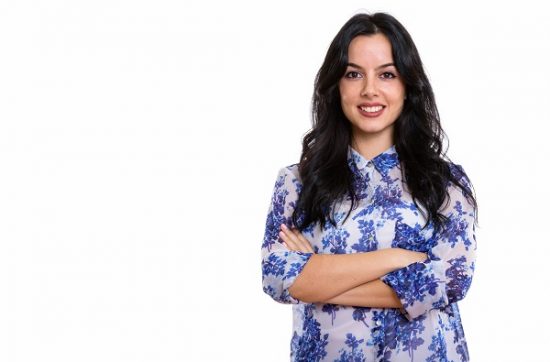 Studio shot of a young happy Italian businesswoman smiling