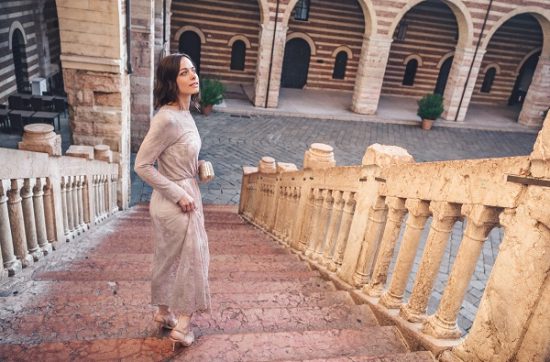 Beautiful attractive Spanish woman posing standing on stairs