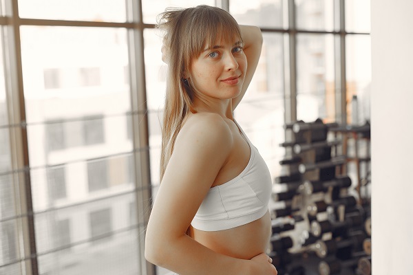 Beautiful smiling German lady is engaged in a yoga studio while exercising all alone