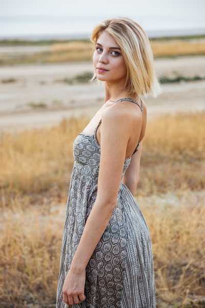 Beautiful young Belarusian woman standing outdoors posing for the camera