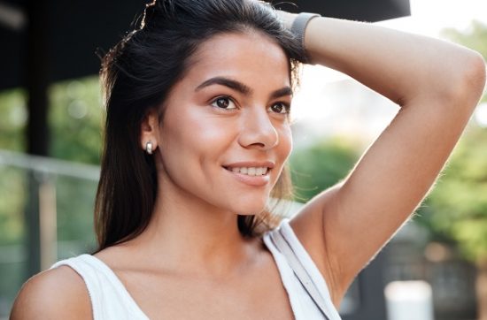 Young smiling Costa Rican lady wearing a white shirt