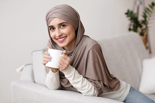 Smiling Egyptian woman with a cup of coffee