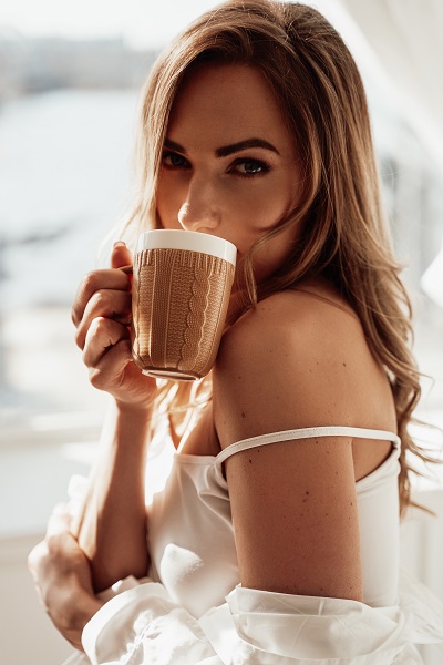 Beautiful Armenian lady drinking tea after waking up in the early morning