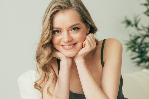 Smiling attractive Latvian girl sitting all alone looking in a camera