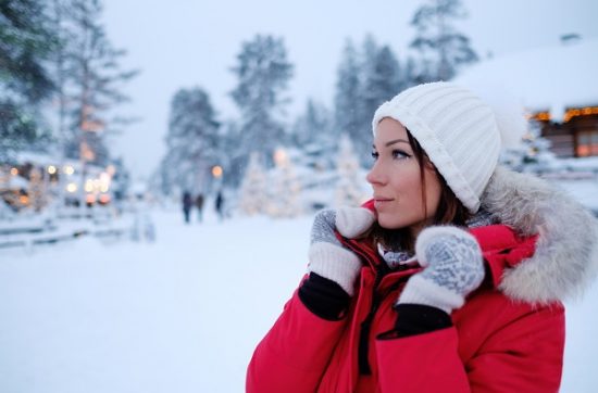 Happy attractive Swedish woman posing for the camera in a snow landscape