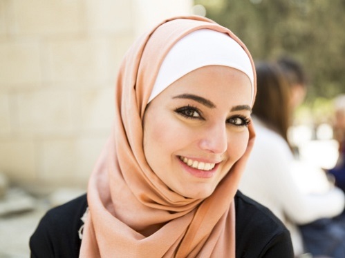 Smiling young Jordanian lady posing in front of a camera